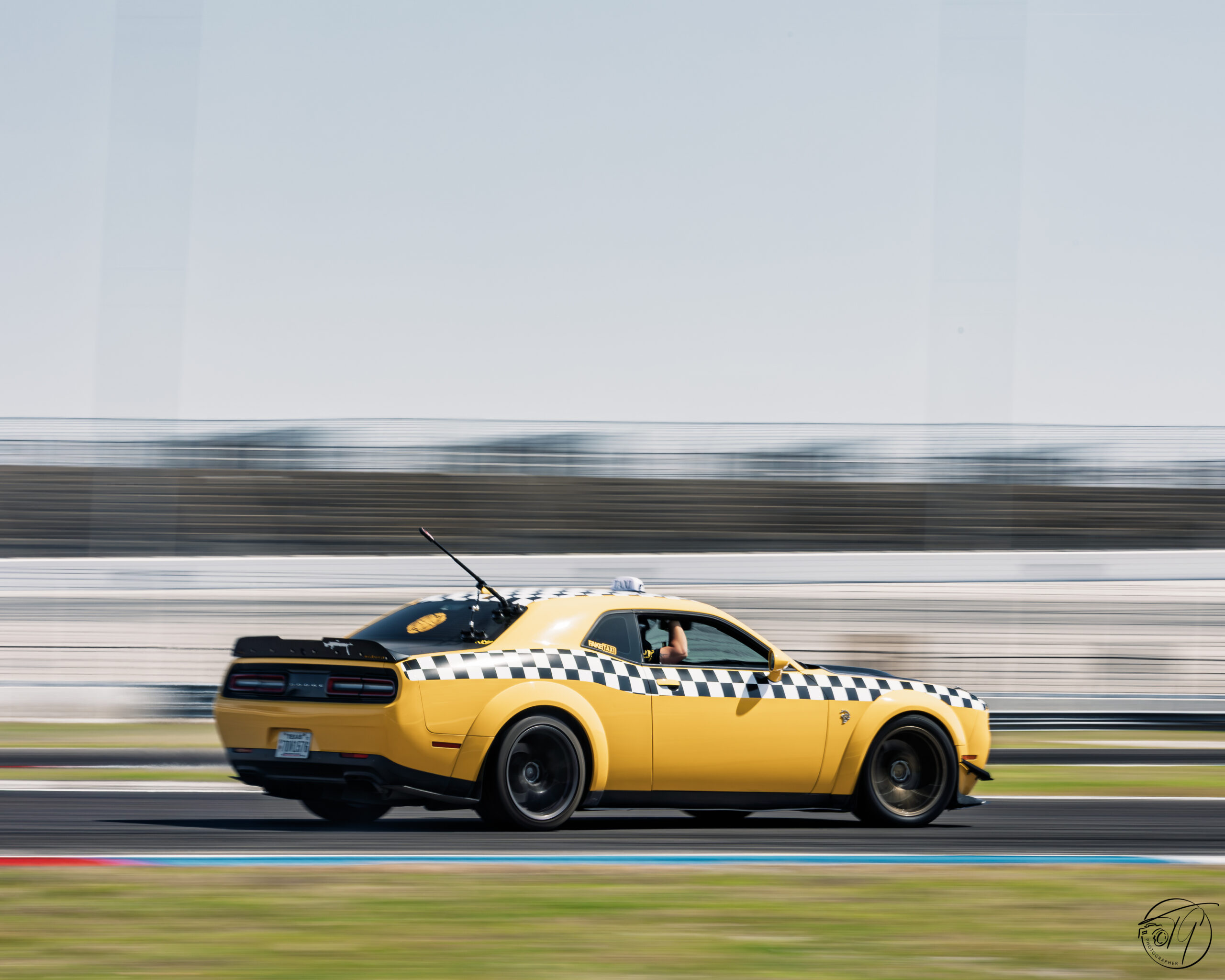 Yellow car at speed on the drag strip